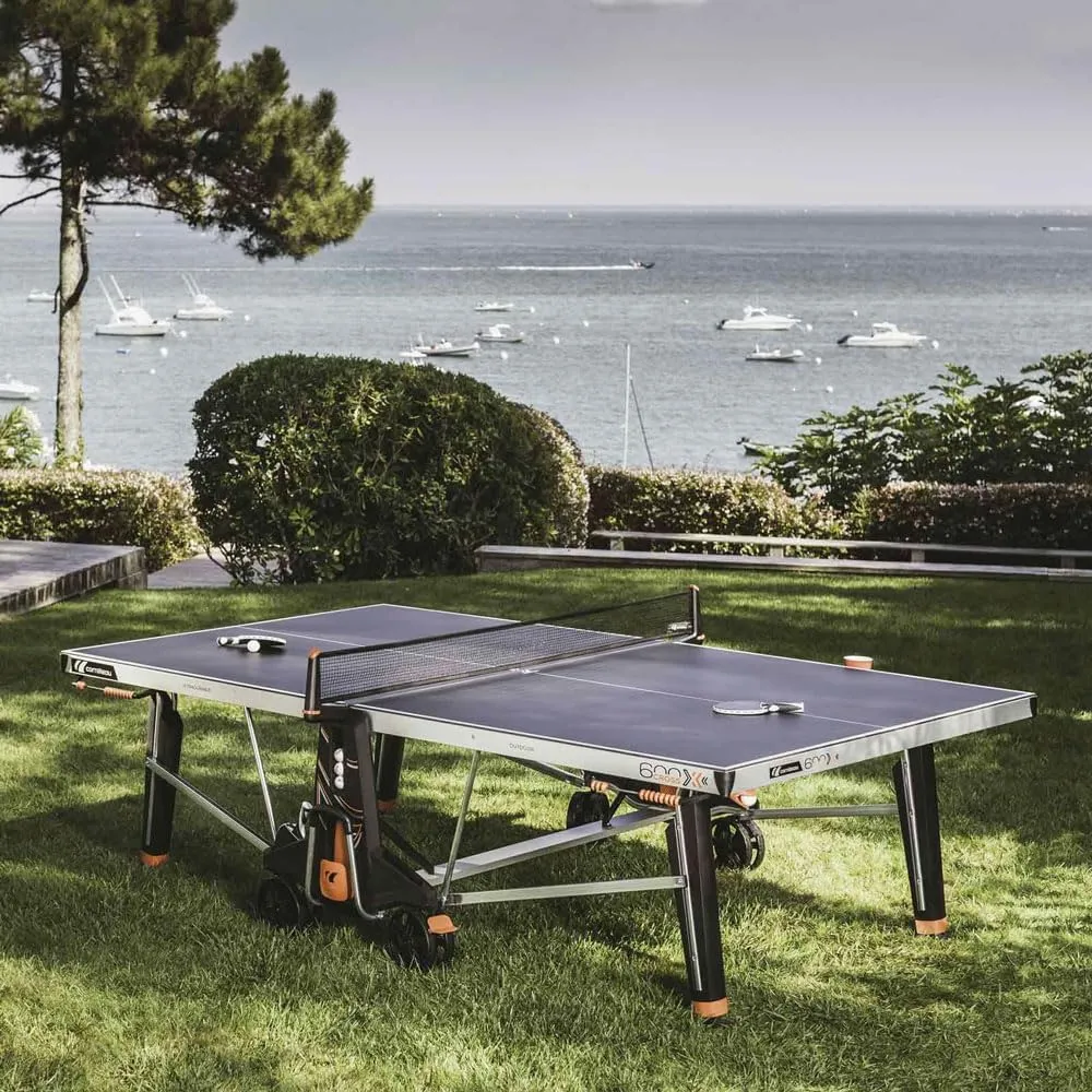 CORNILLEAU - 600X Outdoor Table Tennis Table - Folding & Compact - Weather and Schockproof - 7mm Laminate Top - Cup Holder - Point Counters - Ball Storage & Dispensers - Blue or Black